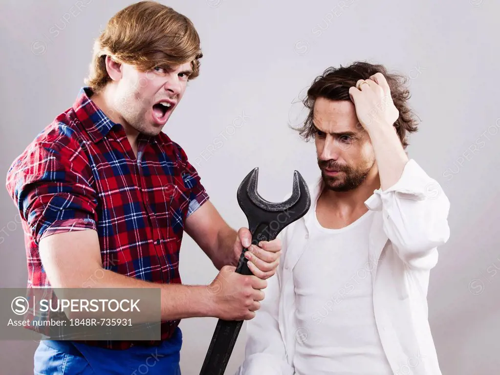 Two men with a giant wrench