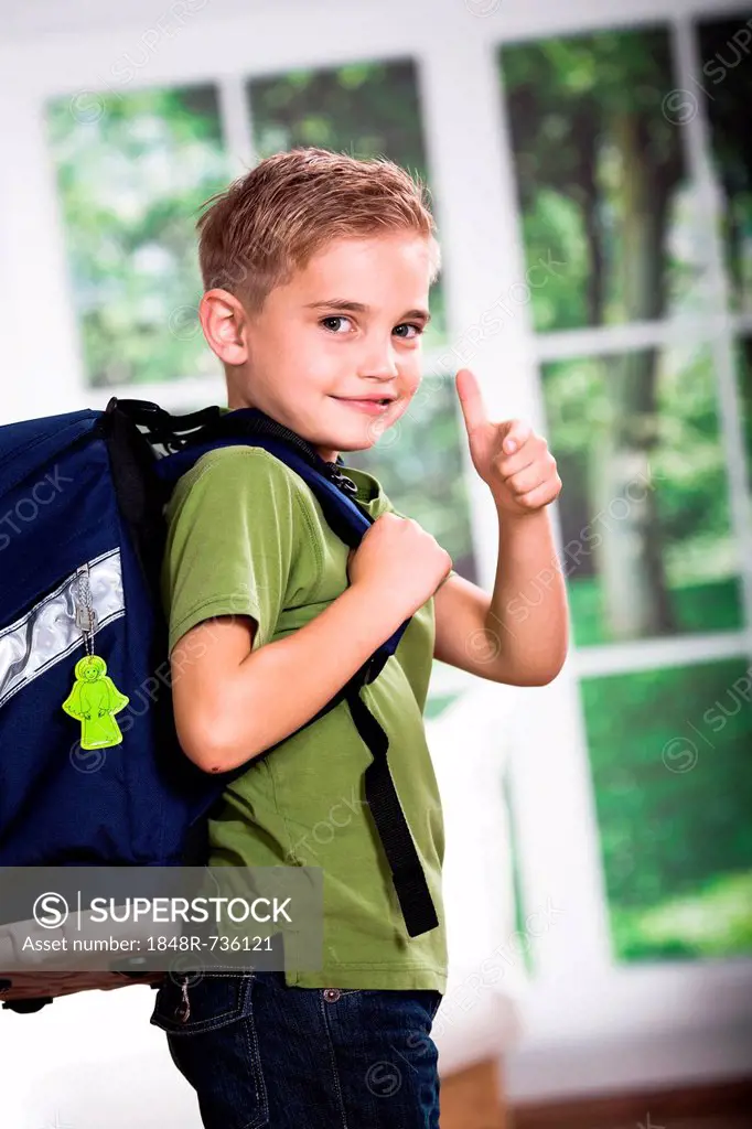 A first grader school boy with school bag