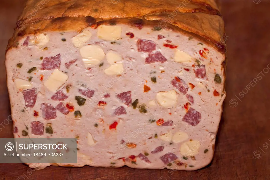 Leberkaese, meat loaf, pizza-style, on a wooden board