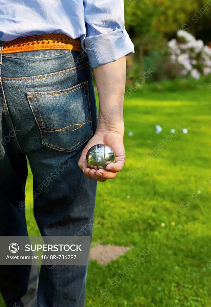Man playing boules, petanque, preparing to throw, Hesse Germany, Europe