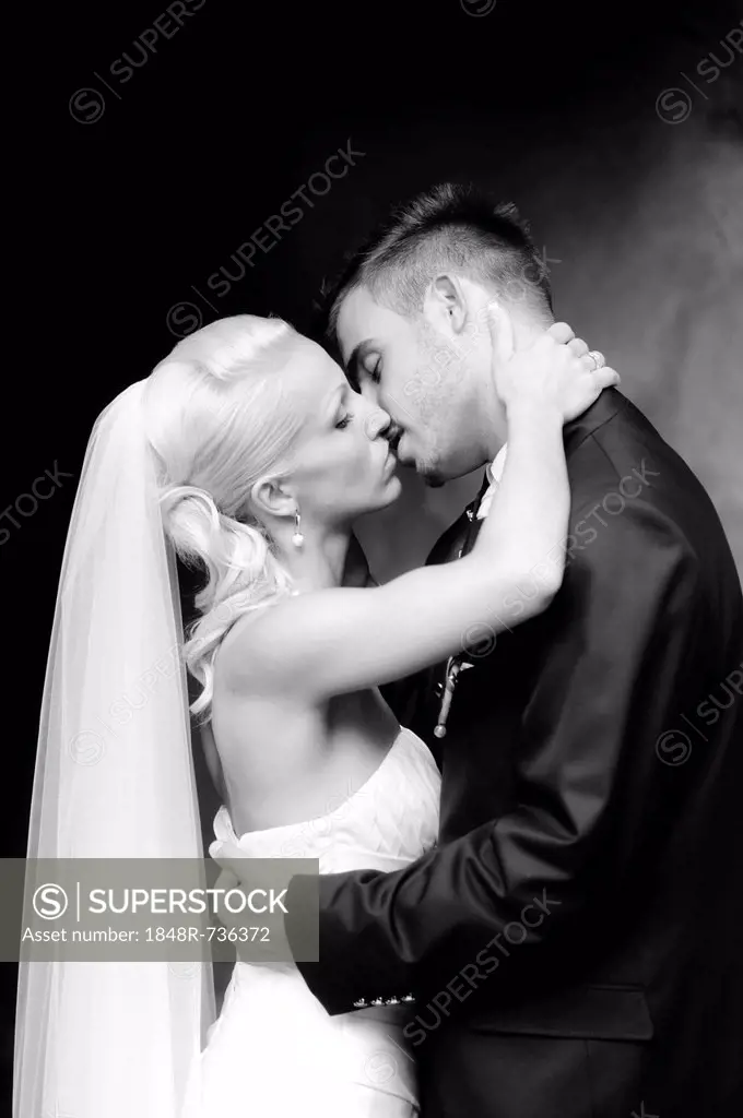 Wedding, bride and groom kissing
