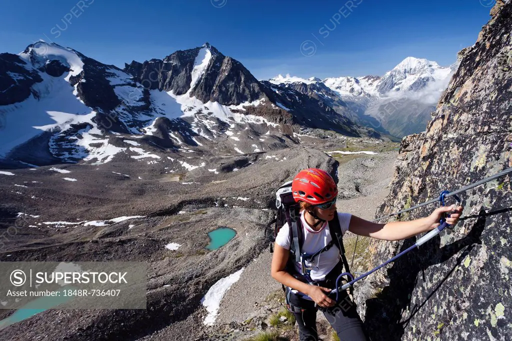 Mountaineer during ascent via the fixed rope route to Tschenglser Hochwand above Duesseldorfhuette hut in Sulden, mountains Vertainspitze, Hoher Angel...