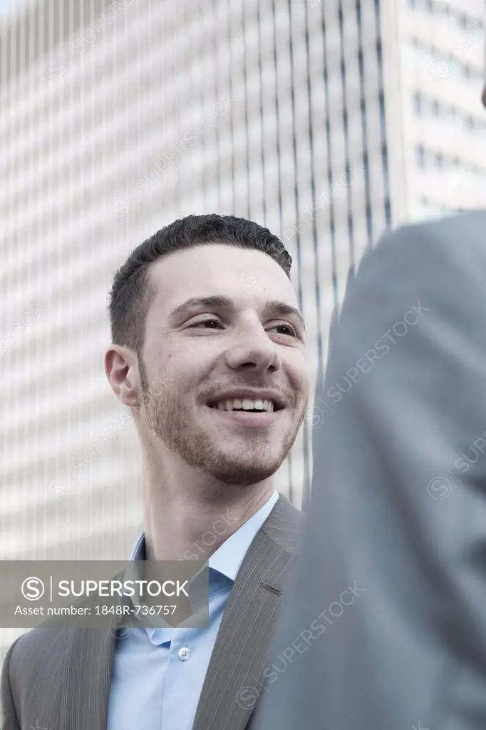 Businessman smiling at his business colleague