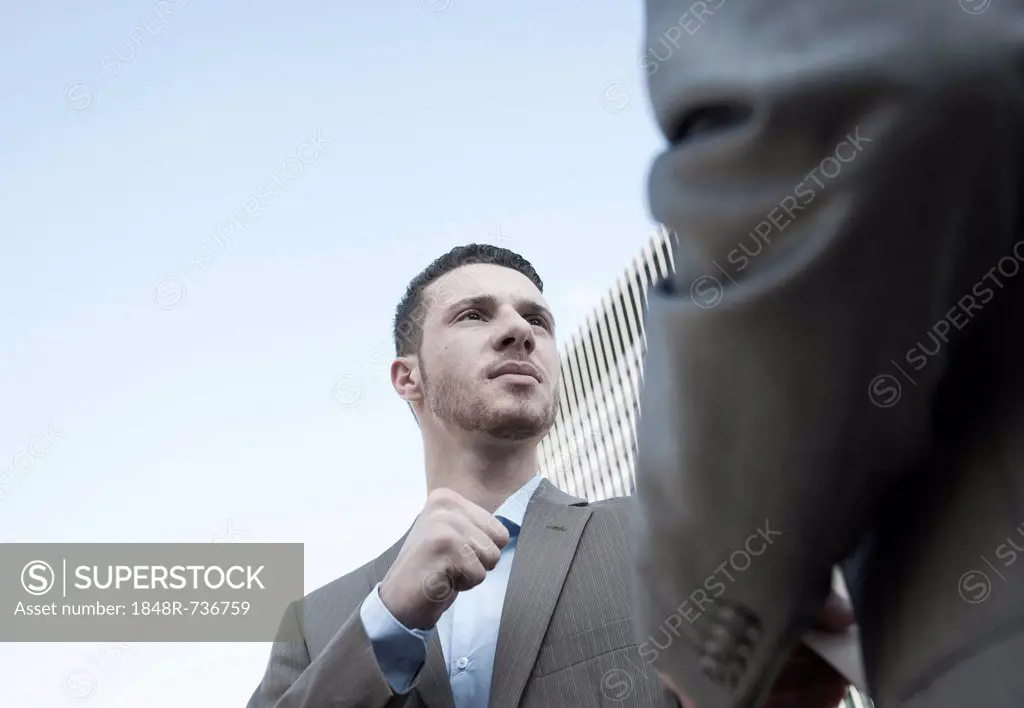Businessman staring aggressively at his business colleague