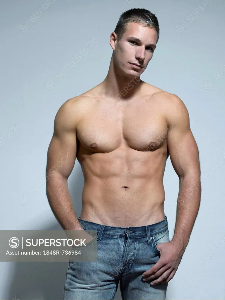 Man with a naked torso wearing a pair of jeans