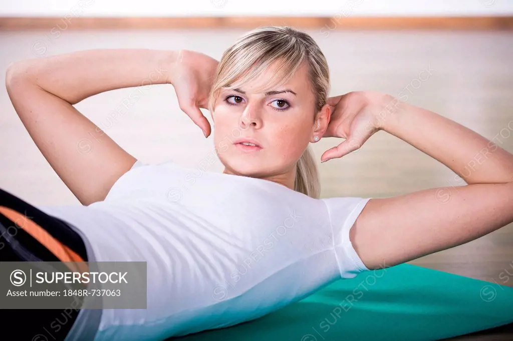 Young woman in sport dress, exercising