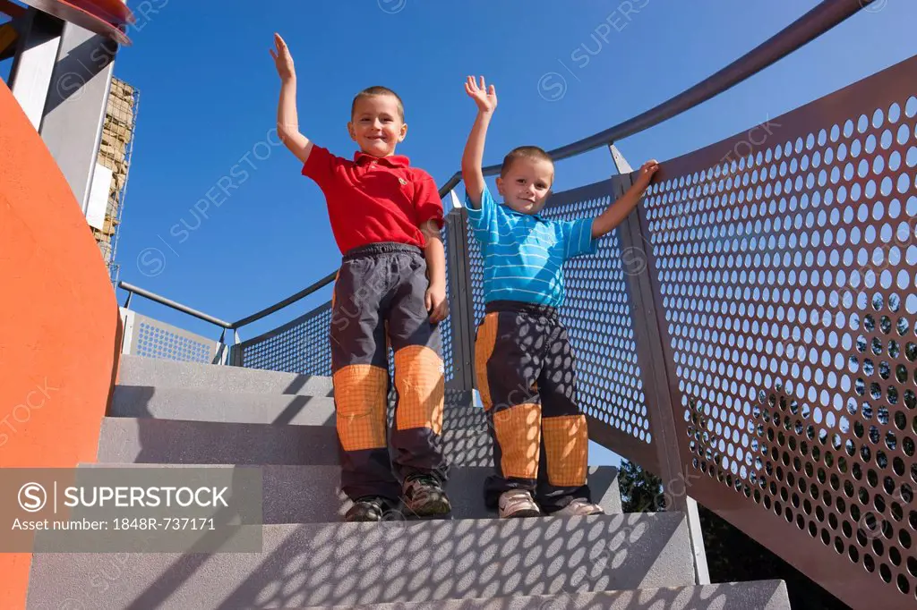 Boys, 6 and 4 years, on a staircase