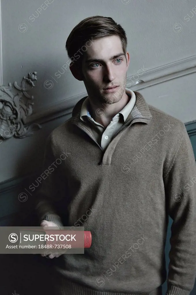 Man holding a book in the stairwell, nostalgic portrait