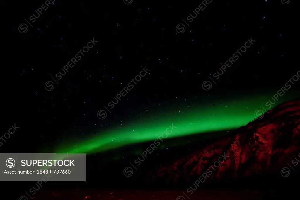 Northern polar lights (Aurora borealis), green, over frozen Yukon River, Dawson City facing Moose Hide, Yukon Territory, Canada