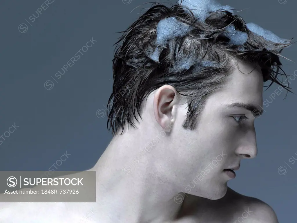Beauty portrait of a young man washing his hair