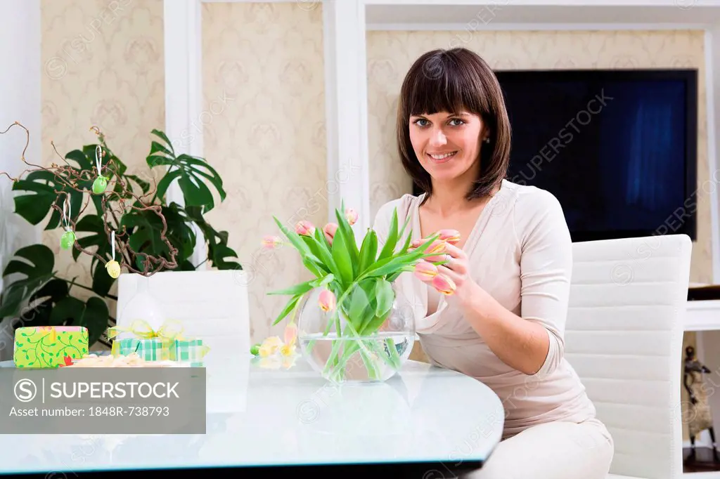 Young woman with a bunch of flowers and Easter decoration