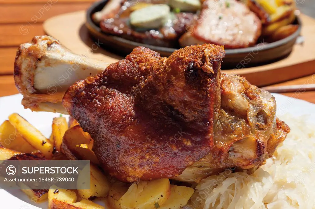 Grilled pork knuckle with fried potatoes and sauerkraut