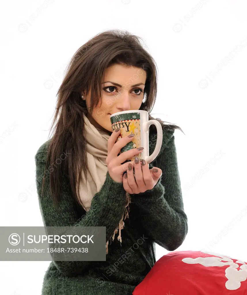 Young woman drinking from a large tea mug