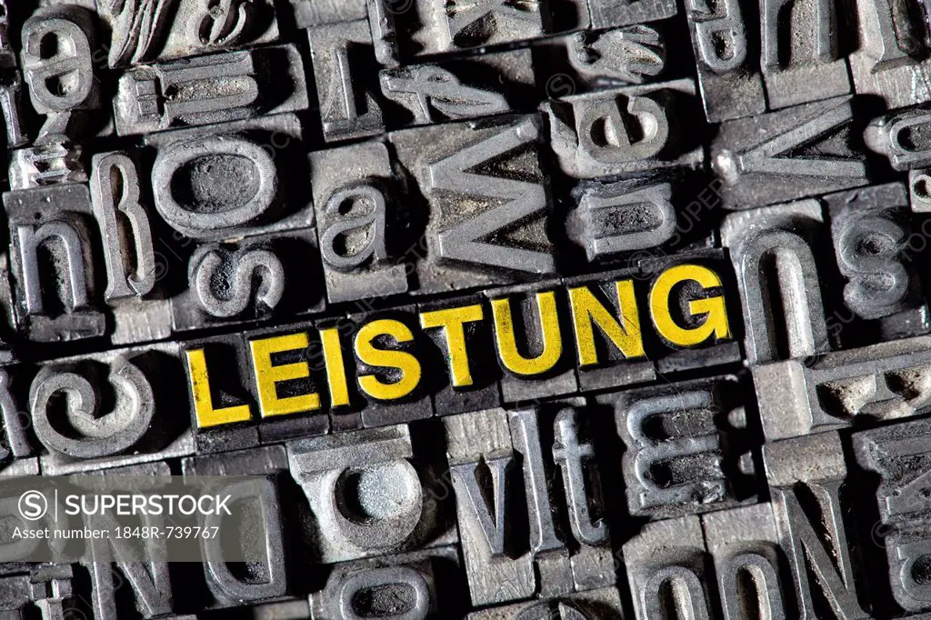 Old lead letters, lettering LEISTUNG, German for effort