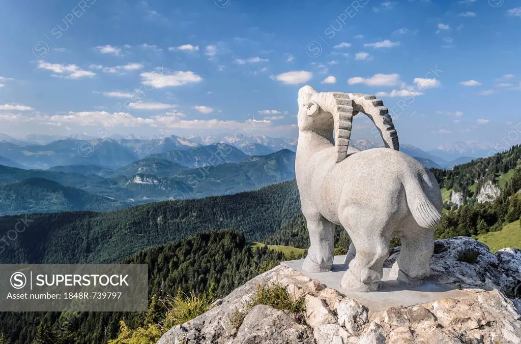 Statue of an ibex in front of the mountain ranges of the Karwendel massif, Bavaria, Germany, Europe