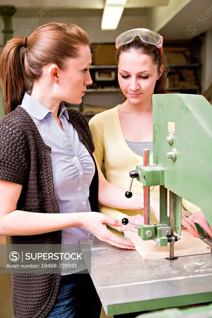 Young female teacher and a teenage schoolgirl in the handwork classroom