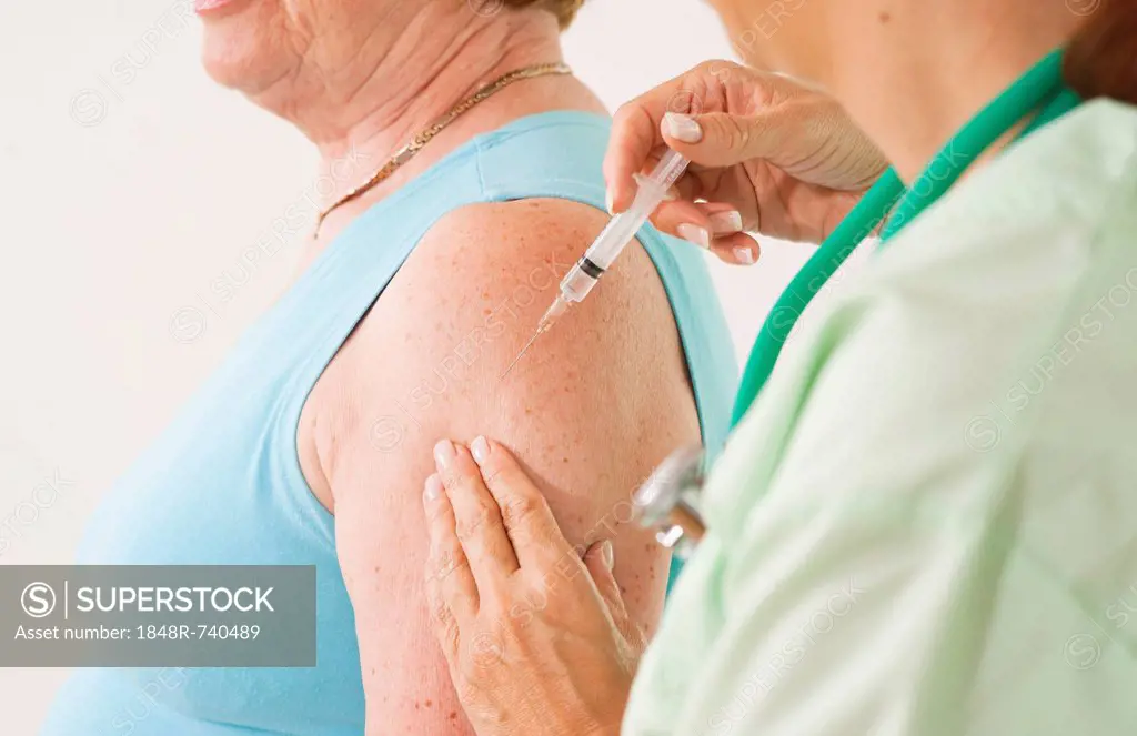 Patient receiving an injection from her doctor, vaccination