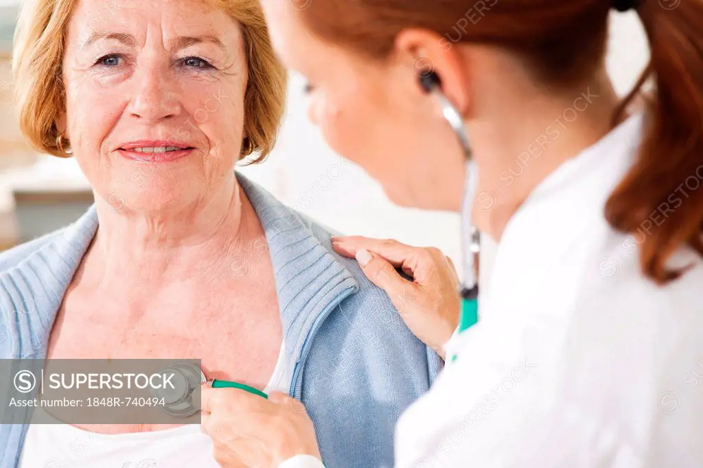 Patient being monitored by her family doctor with a stethoscope