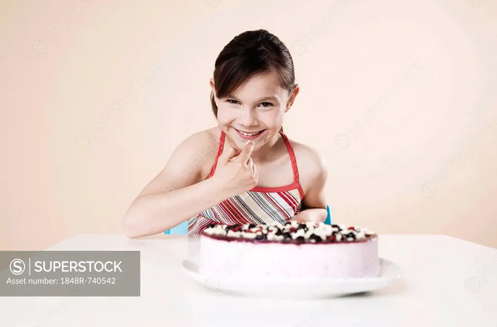 Girl nibbling from a cake