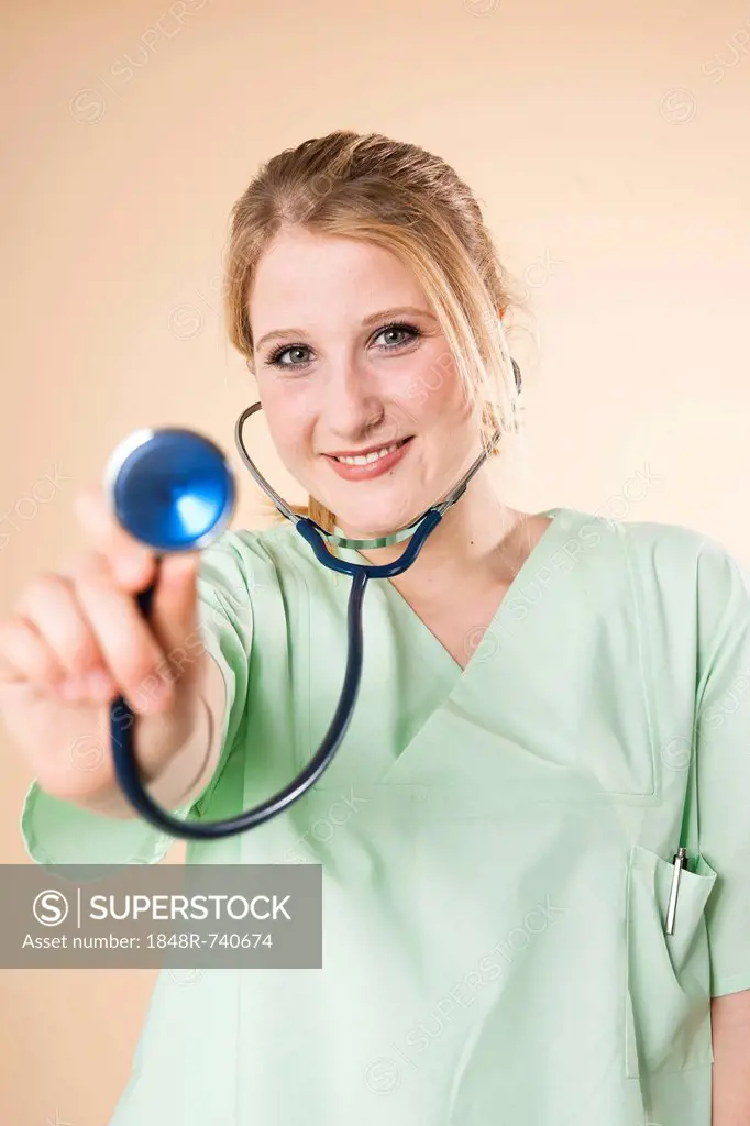 Nurse holding a stethoscope towards the front