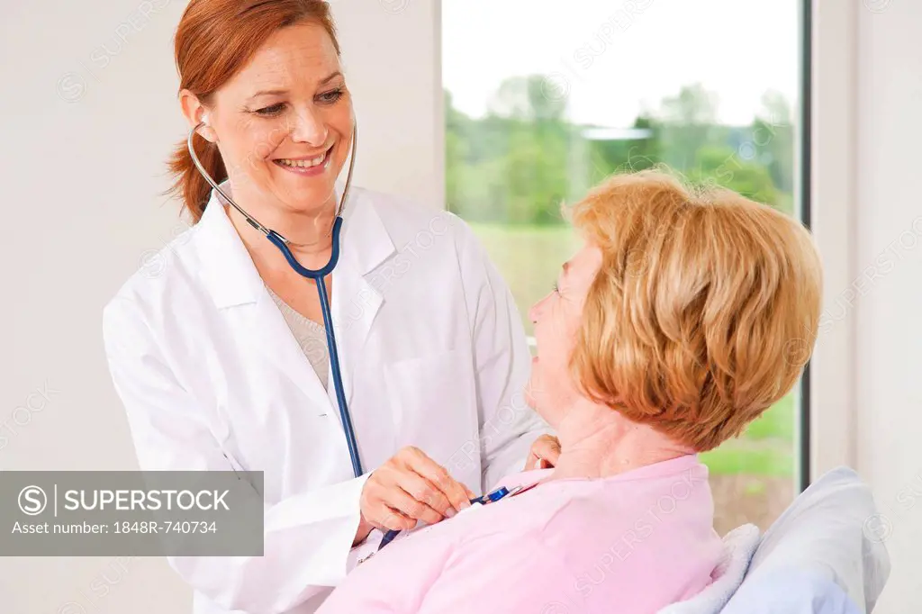 Patient being monitored by her family doctor with a stethoscope