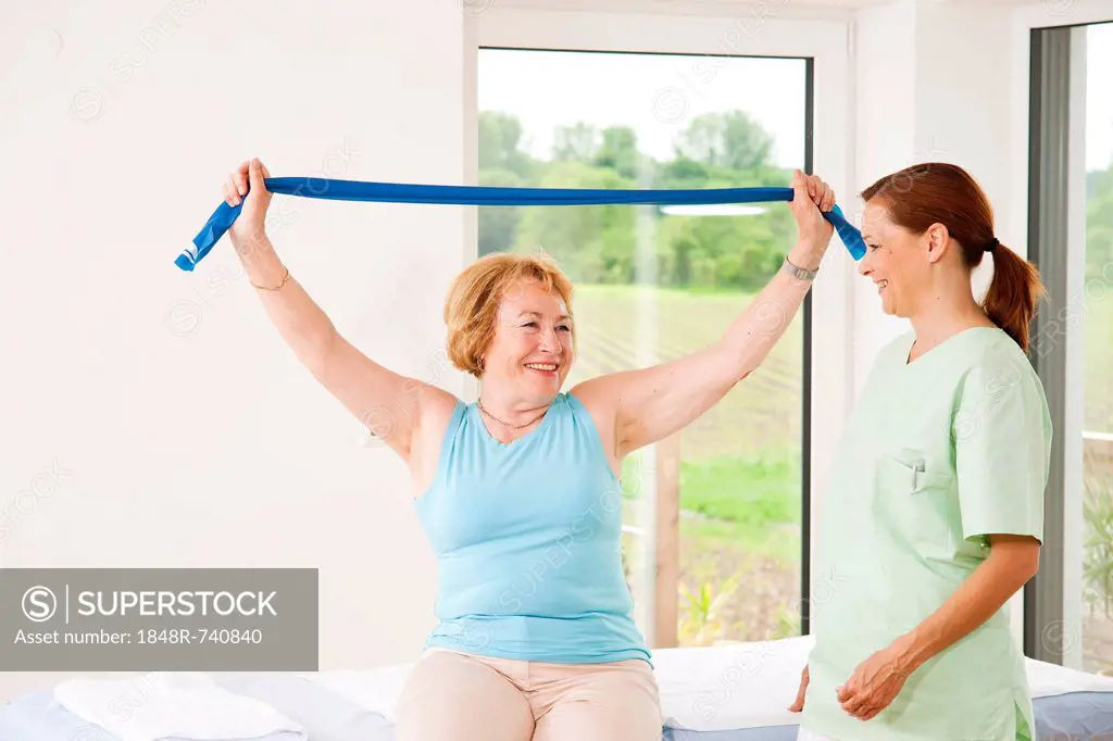 Patient doing physical therapy with a band in a physiotherapist's practice