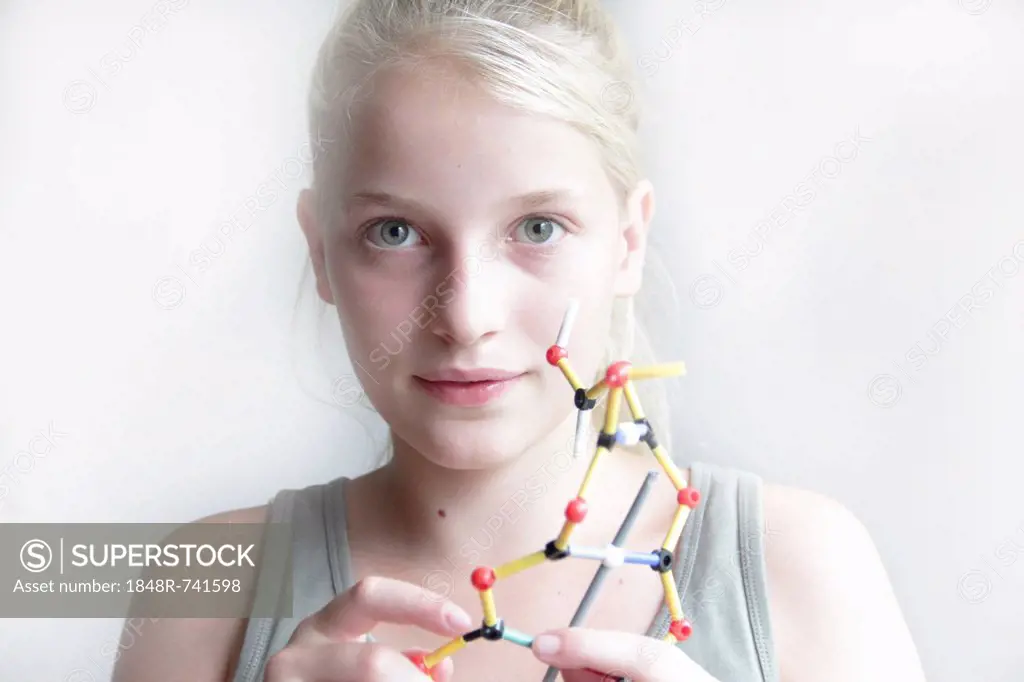 Girl constructing a molecular model