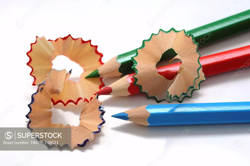 Wooden coloured pencils, sharpened with a sharpener and shavings