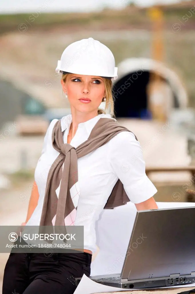 Young female constructor at building site