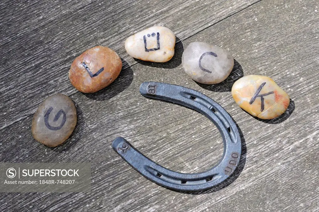 Stones with letters forming the word Glueck, German for luck, and a horseshoe