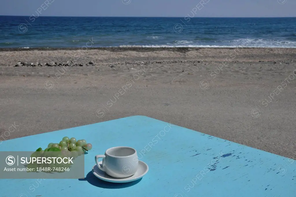 Bright blue table with a coffee cup and a bunch of grapes, Panos restaurant, beach, Karterádos, Santorini, Cyclades, Greek island, Greece, Europe