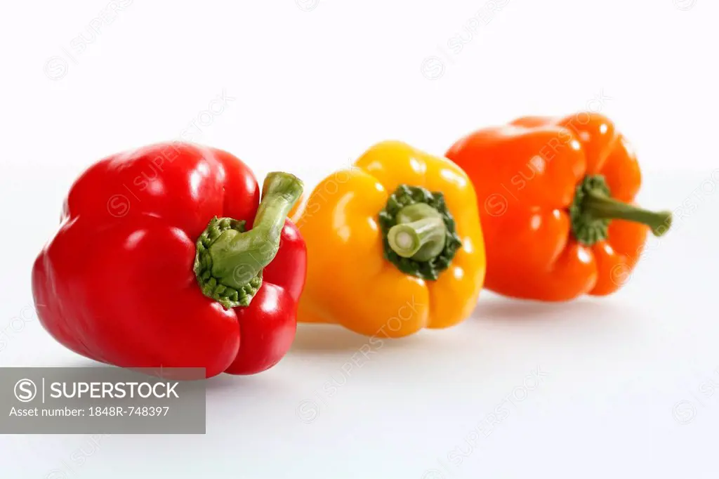 Three bell peppers, red, yellow and orange