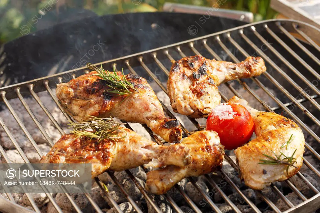 Grilled chicken legs on a grill rack