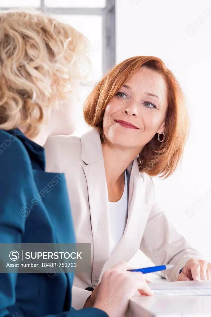 Manager working in an office with a trainee