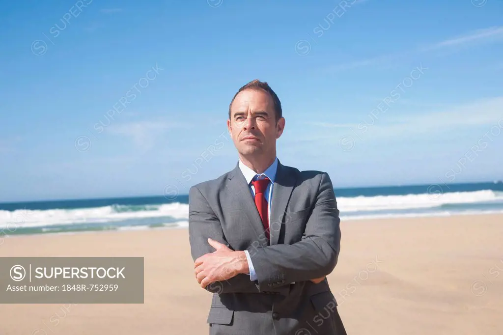 Businessman standing at the beach
