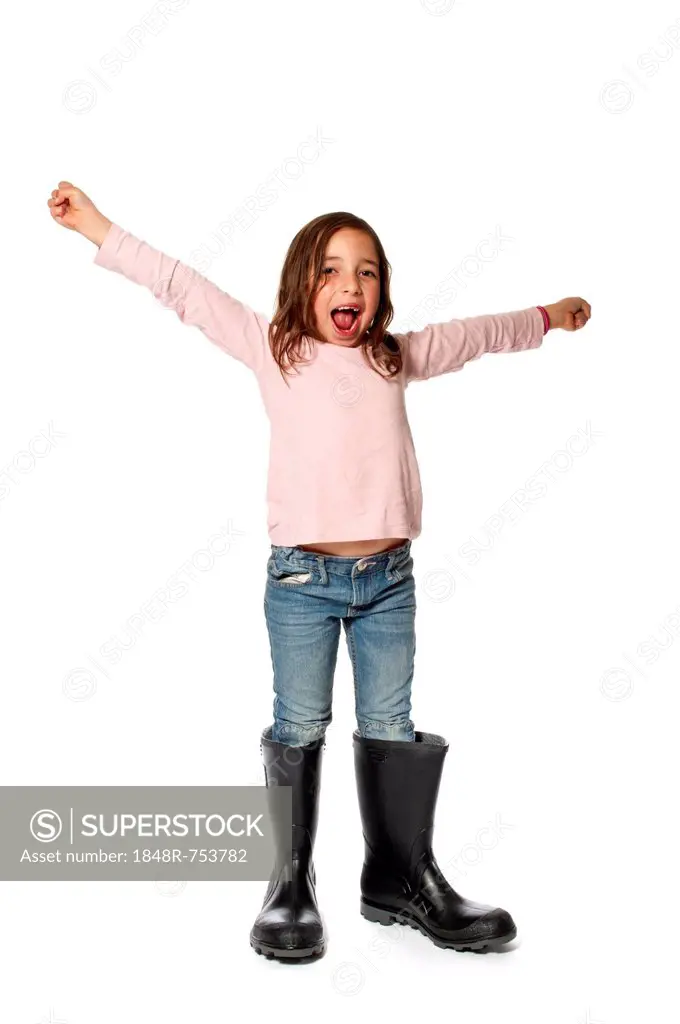 Seven-year-old girl with too big rubber boots