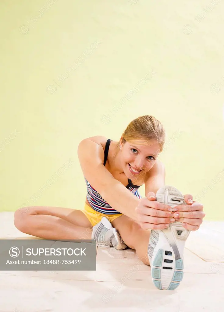 Young woman doing stretching exercises