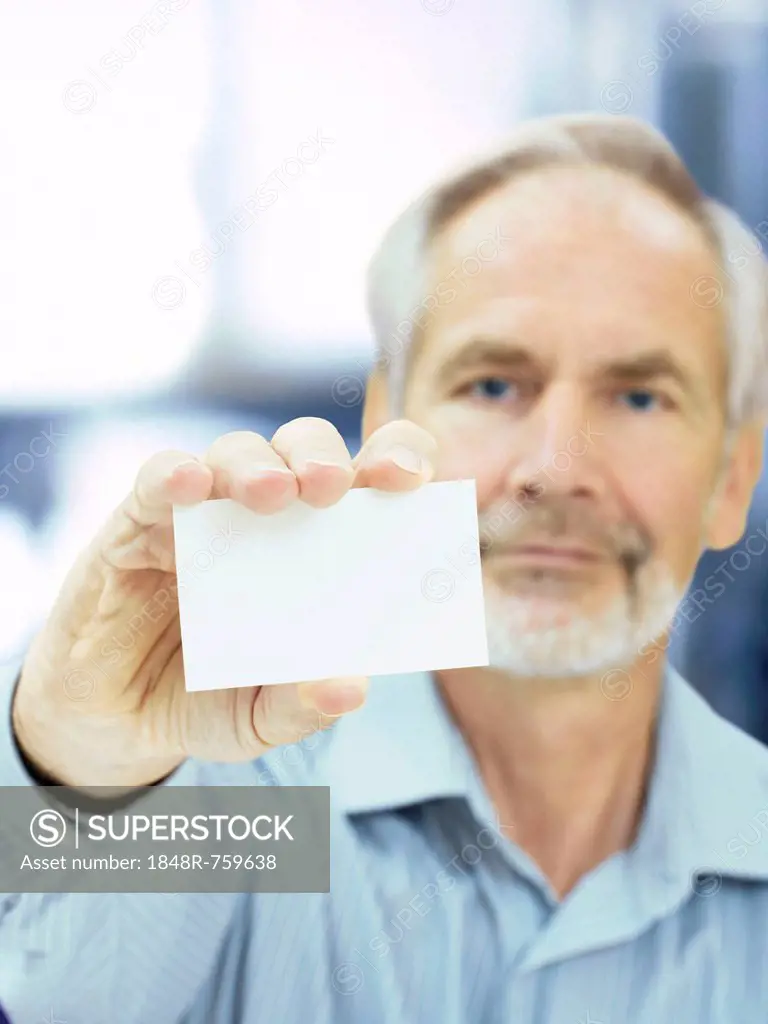 Senior, holding a blank business card