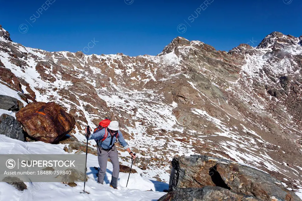 Hiker during the ascent of Hintere Eggenspitze Mountain in the Ulten Valley, looking towards Zufrittspitz Mountain, Alto Adige, Italy, Europe