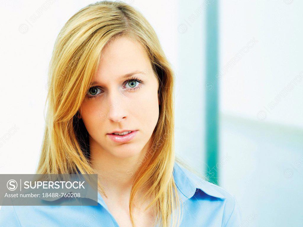 Young woman wearing a blue blouse, portrait - SuperStock