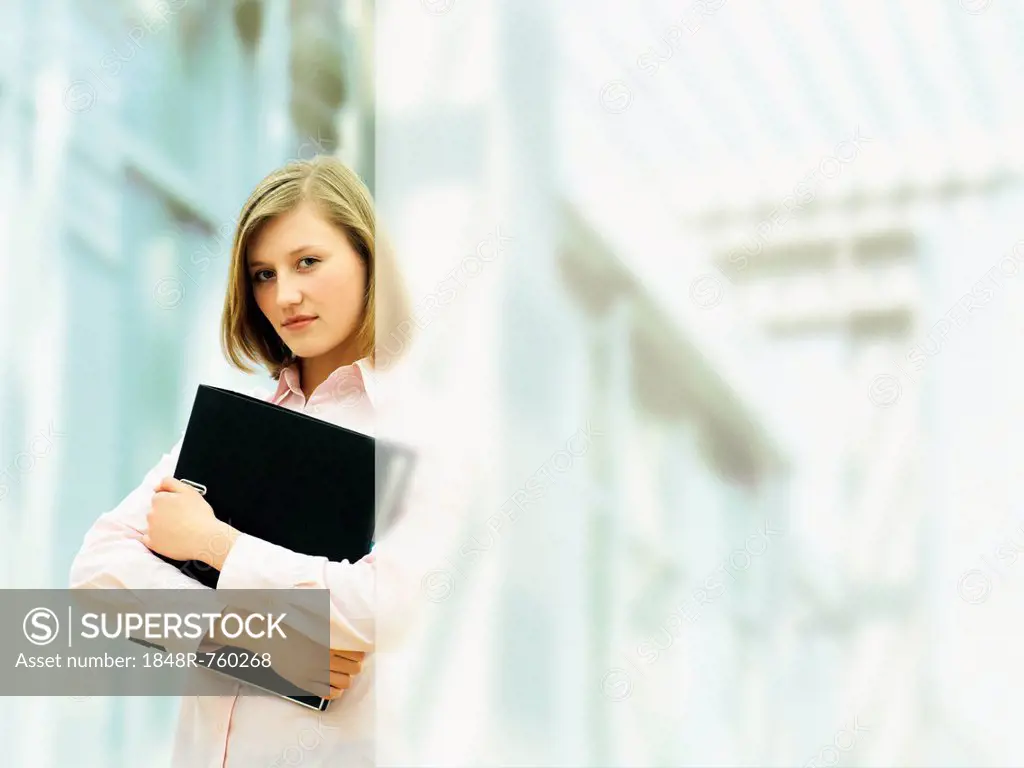 Businesswoman holding a ring binder