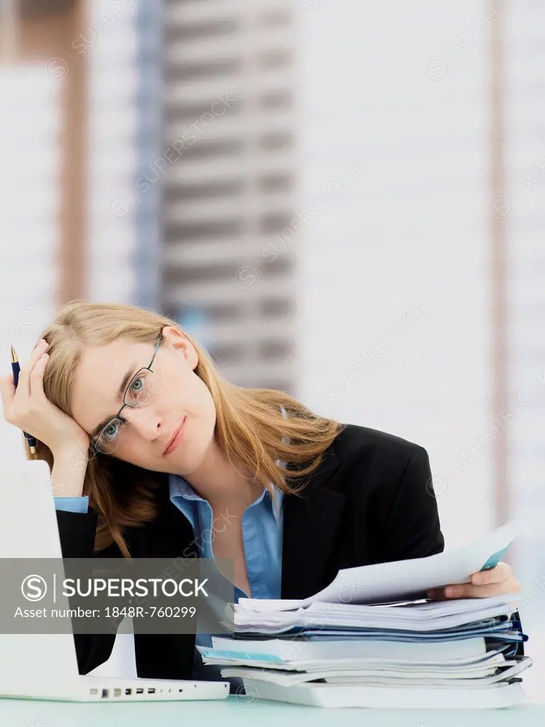 Businesswoman wearing glasses and using a laptop, accounting