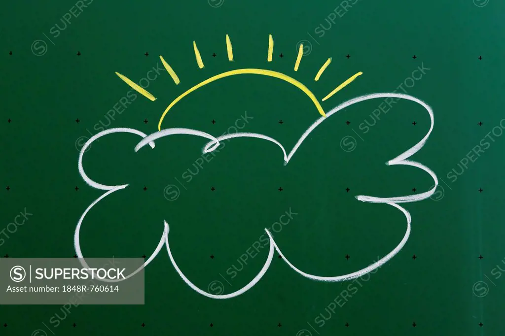 Cloud with a sun drawn with chalk on a blackboard, Germany