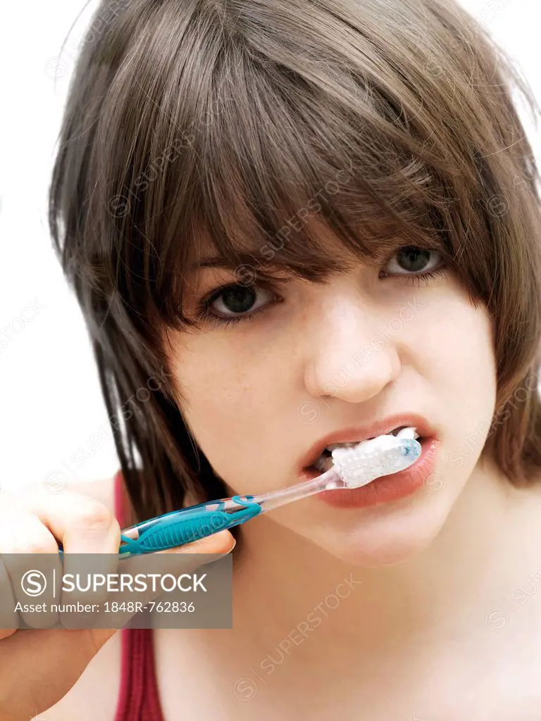 Girl, teenager, brushing her teeth