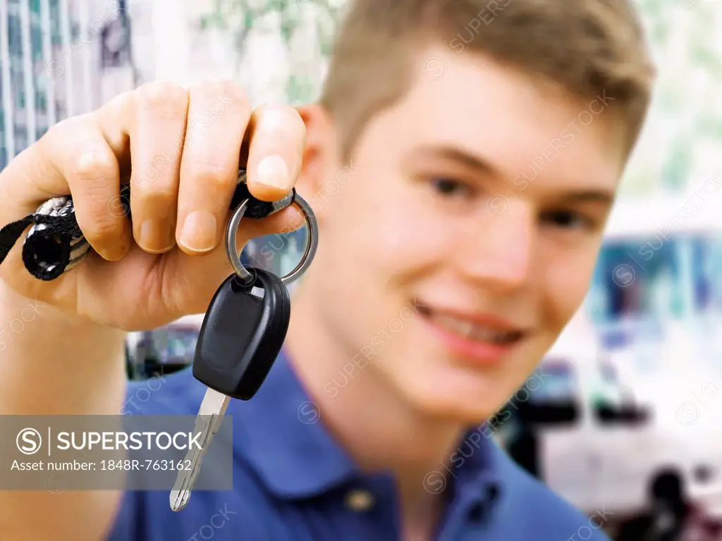 Teenager holding car keys after passing a driving test