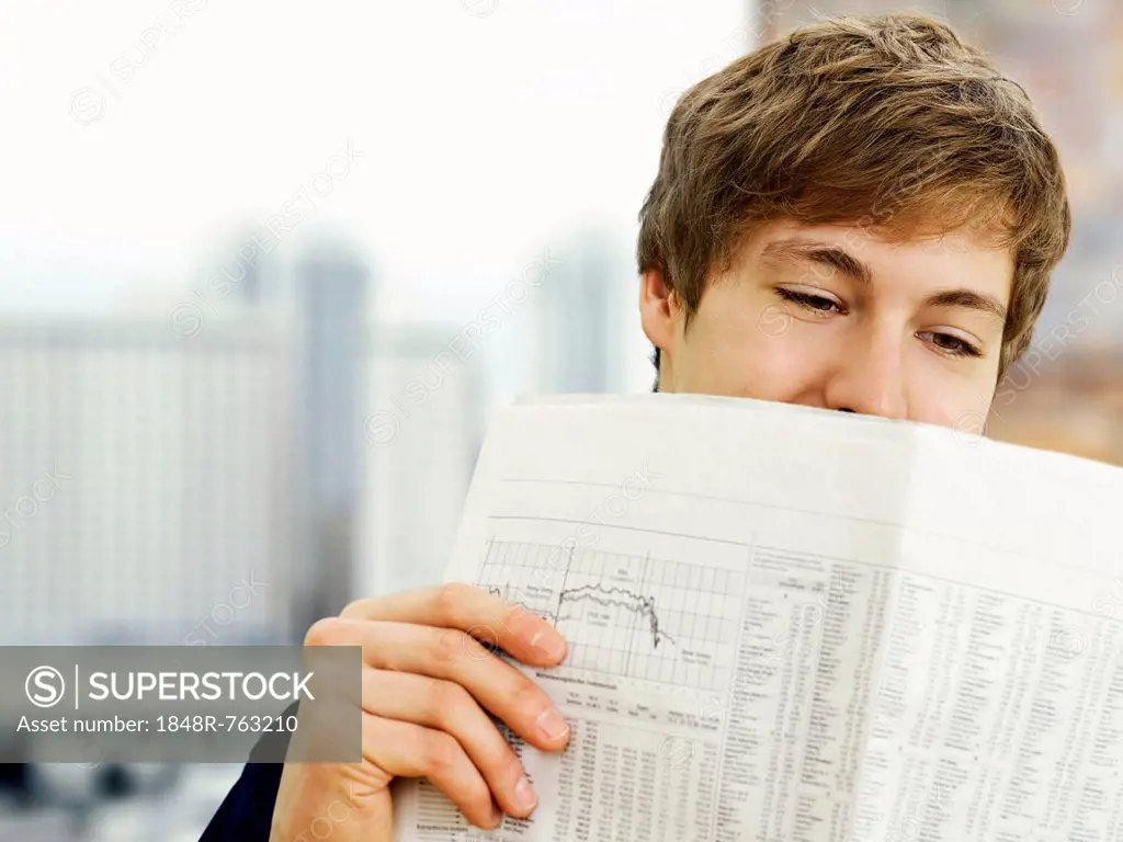 Businessman reading a newspaper in an office