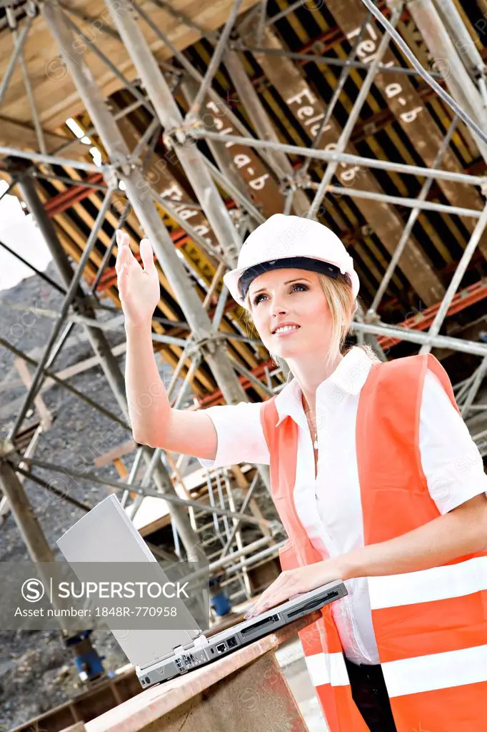 Young female constructor at building site of a new motorway, Germany