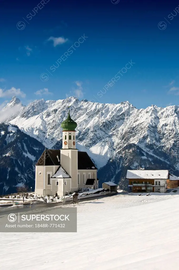 Parish and pilgrimage church of St. Bartholomew, Baroque church, in front of mountain range, Bartholomäberg, Montafon, Vorarlberg, Austria
