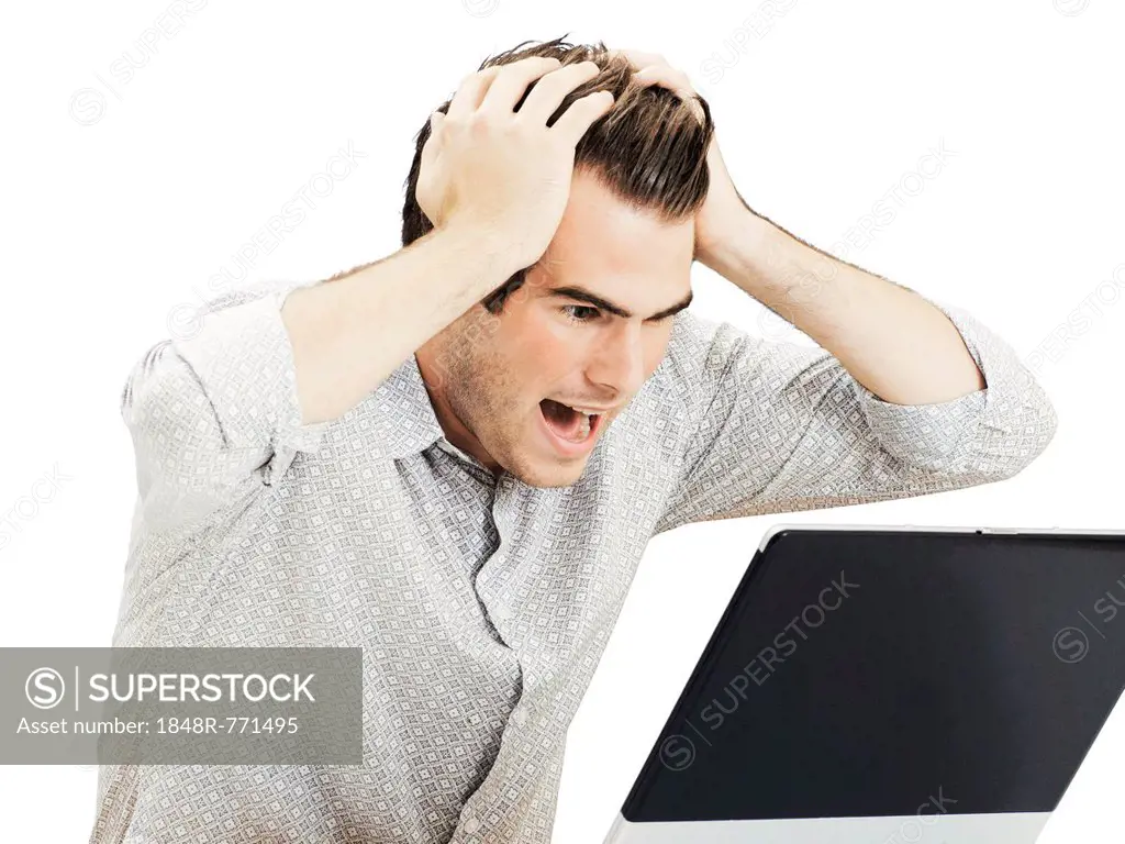 Businessman with laptop, tearing his hair in despair