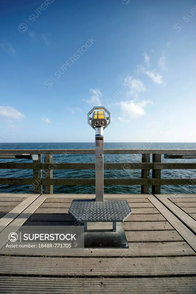 Coin-operated binoculars on a pier in front of the blue sea and blue sky, Boltenhagen, Mecklenburg-Western Pomerania, Germany